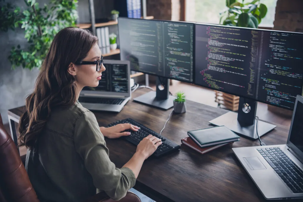 Photo of smart concentrated lady web designer write key words download media database upgrade modern device indoor room workstation